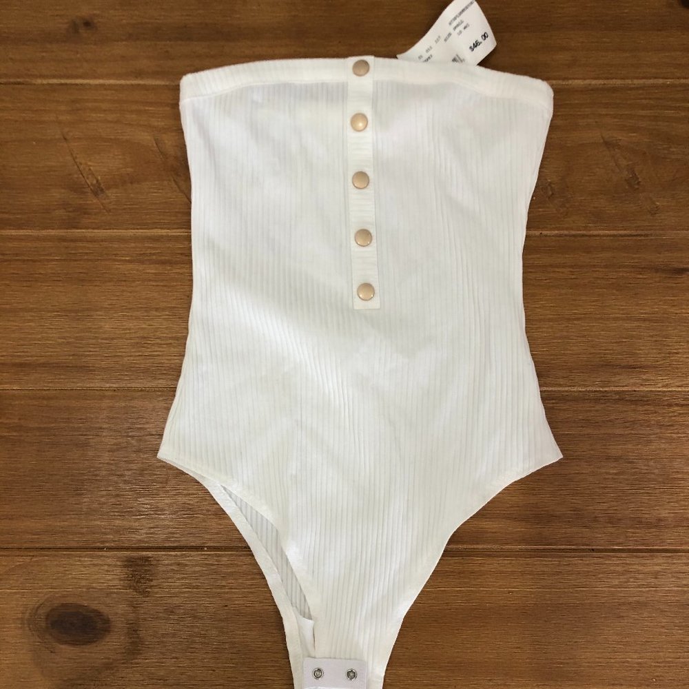 Small, strapless white bodysuit